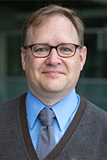 Headshot of male program director with glasses.
