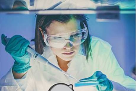 A scientist working with a pipette in a lab.