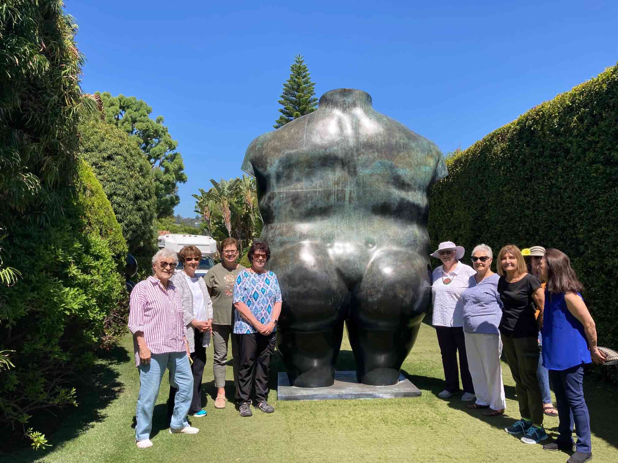 The picture of members next to big monkey statue